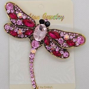 Dragonfly Brooch with Pink crystals on it